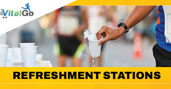 What awaits the runners at the refreshment stations?